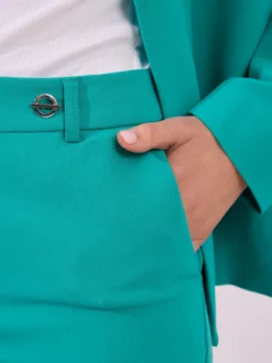 Eleganckie spodnie materiałowe w kolorze intensywnego turkusu